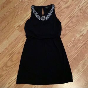 EUC WHBM black jersey sleeveless dress with metallic trim neckline. Size XS.